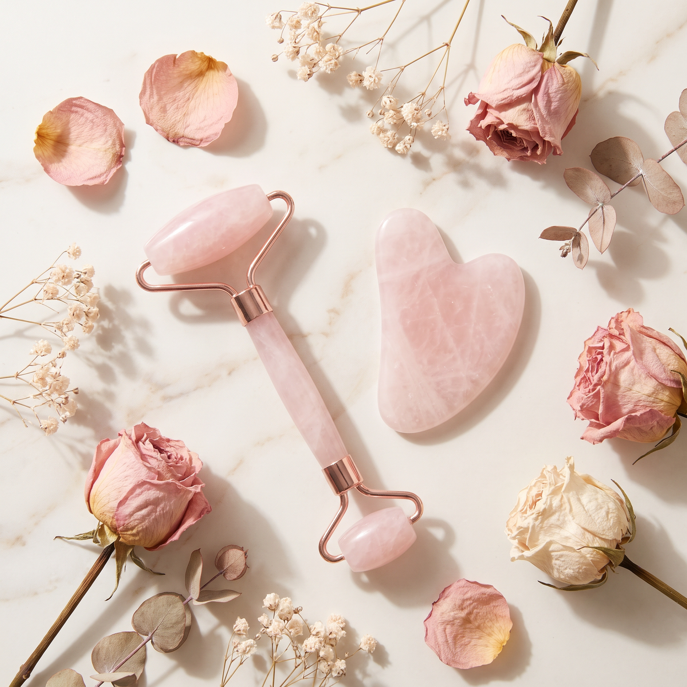 Rose quartz roller and gua sha flat lay