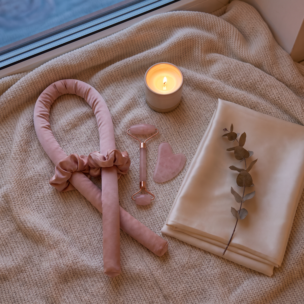 Night ritual set on cosy bed with candle